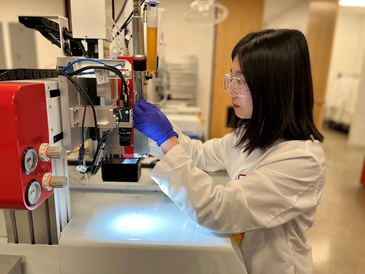 Henkel Associate Application Engineer Olivia Shin works on dispensing equipment